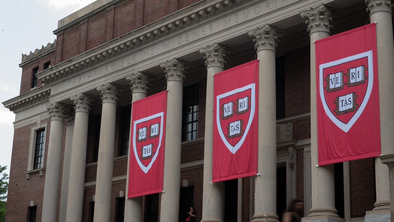 People walk past the Harry Elkins Widener Memorial Library on Harvard's campus on June 5, 2025.