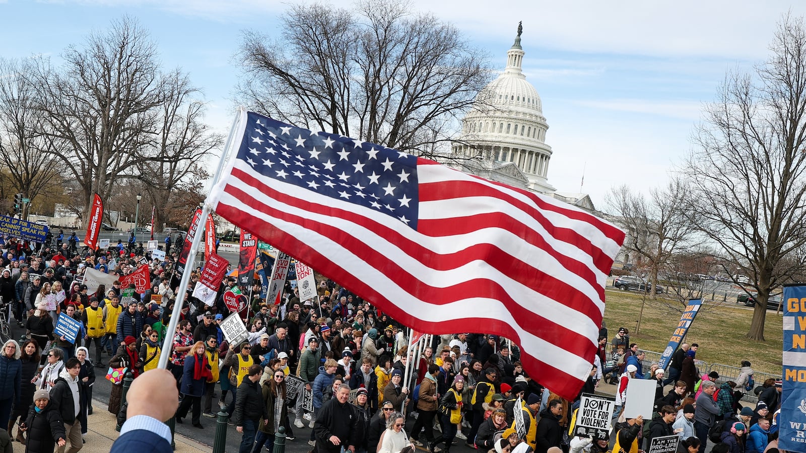 A person waves an American flag as anti-abortion activists march near the U.S. Capitol during the annual March for Life rally on January 23, 2026 in Washington, DC.