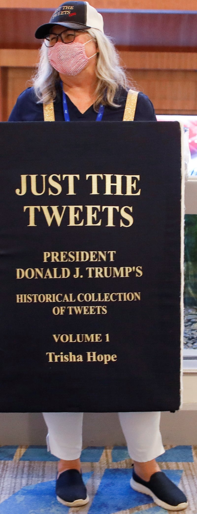 Trisha Hope advertises a collection of Donald Trump's tweets at the Conservative Political Action Conference (CPAC) in Orlando, Florida, on February 26, 2021.