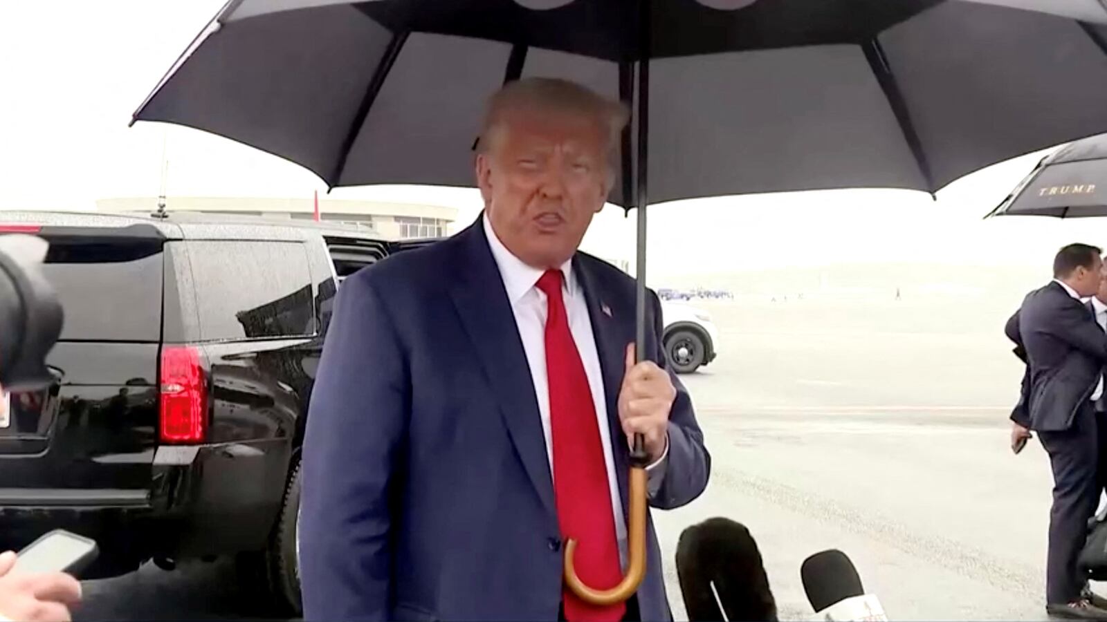 Donald Trump faces reporters as he departs Washington in this still image taken from video at Reagan Washington National Airport in nearby Arlington, Virginia, Aug. 3, 2023.