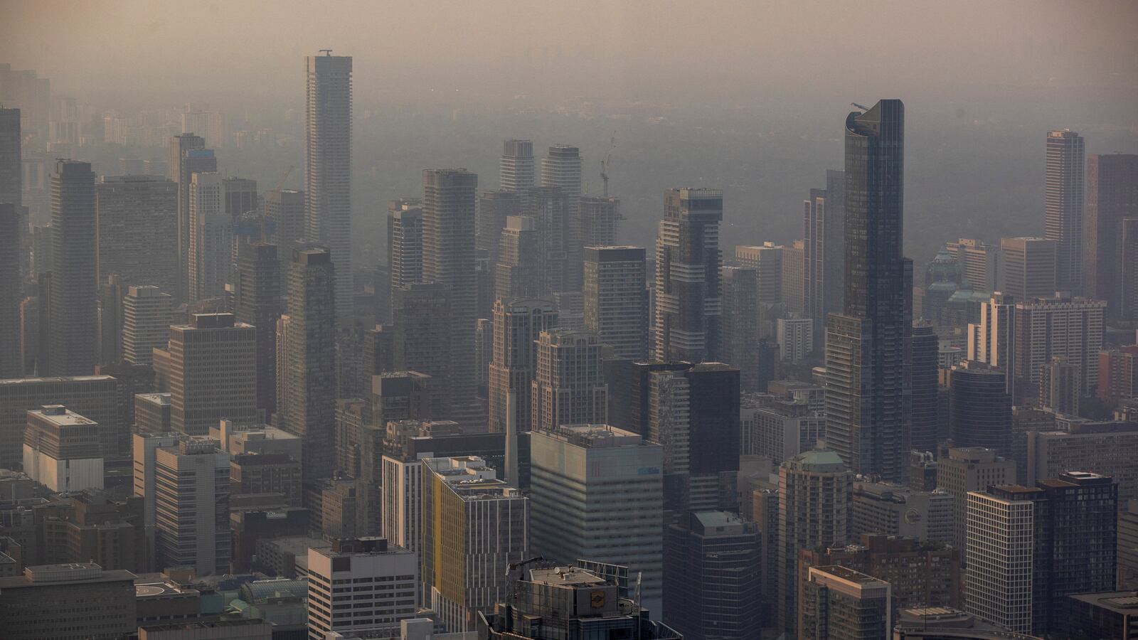 A smokey Toronto skyline is seen from the CN Tower as wildfires in Ontario and Quebec continue to burn, in Toronto, Ontario, Canada, June 6, 2023.