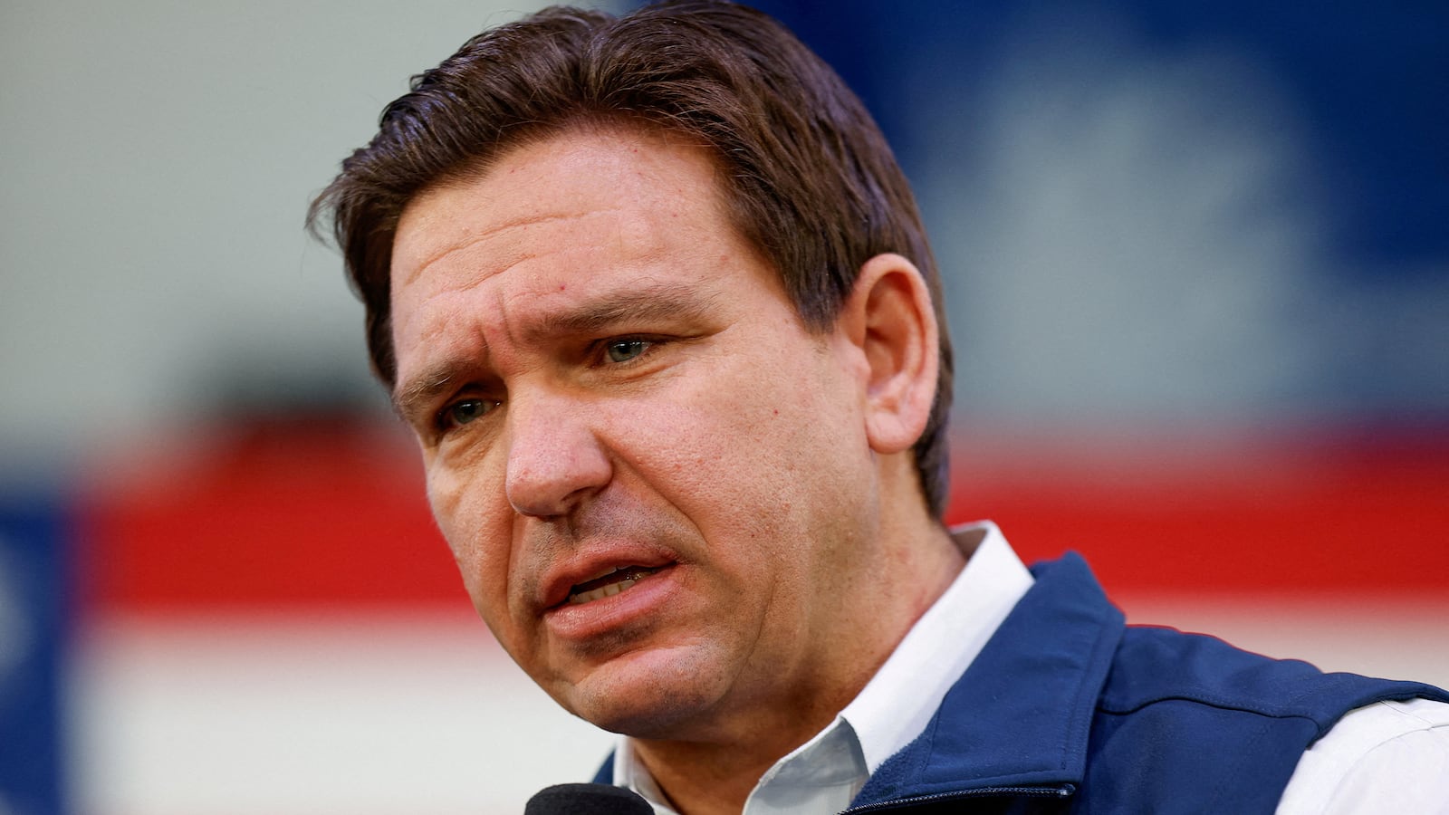 Donald Trump holds a microphone as he speaks during an event.
