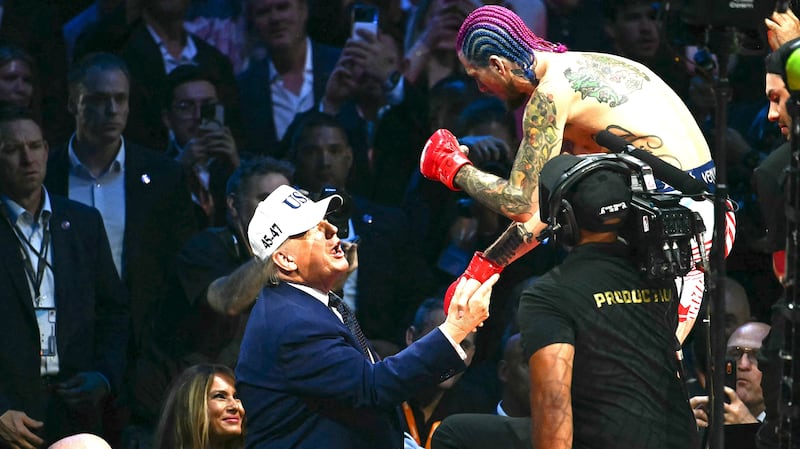 U.S. President Donald Trump speaks with America's Sean O'Malley after O'Malley defeated Canada's Aiemann Zahabi