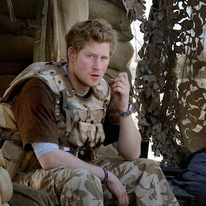 Prince Harry sits with a group of soldiers while on duty on January 2, 2008 in Helmand province, Southern Afghanistan.