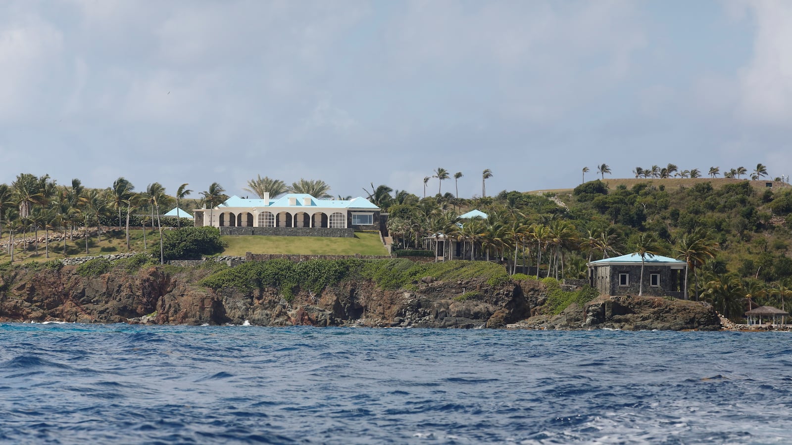 Homes are seen on Little St. James Island from a distance.