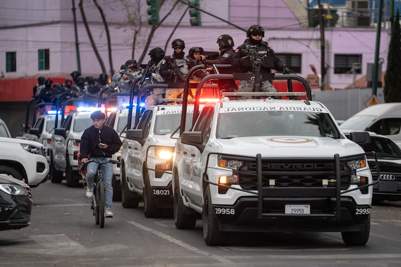 Members of the special units of the National Guard and the Secretaria de Seguridad Ciudadana stand guard in front of the Fiscalia General de la Republica, where the investigation into the operation in which Nemesio Oseguera Cervantes, alias "El Mencho", founder and leading head of the Cartel de Jalisco Nueva, was killed, is underway.