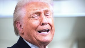 U.S. President Donald Trump speaks to reporters on board Air Force One