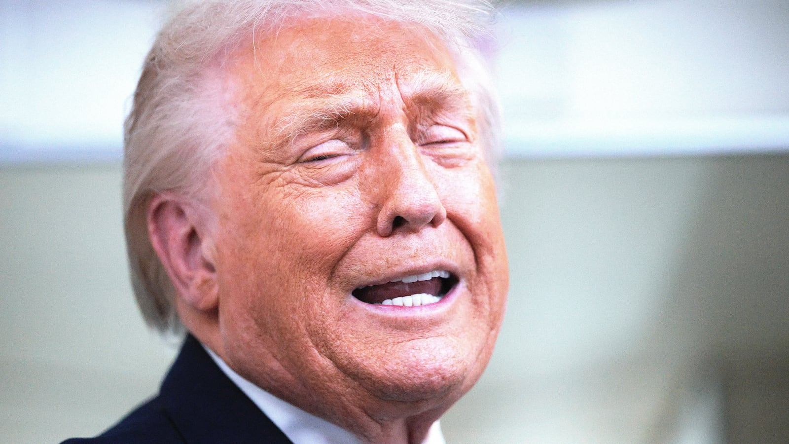 U.S. President Donald Trump speaks to reporters on board Air Force One