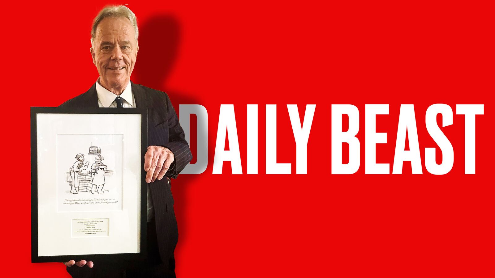 Michael Daly holding his Searchlight Award in front of the Daily Beast logo