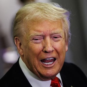 U.S. President Donald Trump speaks to reporters aboard Air Force One en route to the White House on November 2, 2025 after taking off from Palm Beach International Airport in West Palm Beach, Florida.