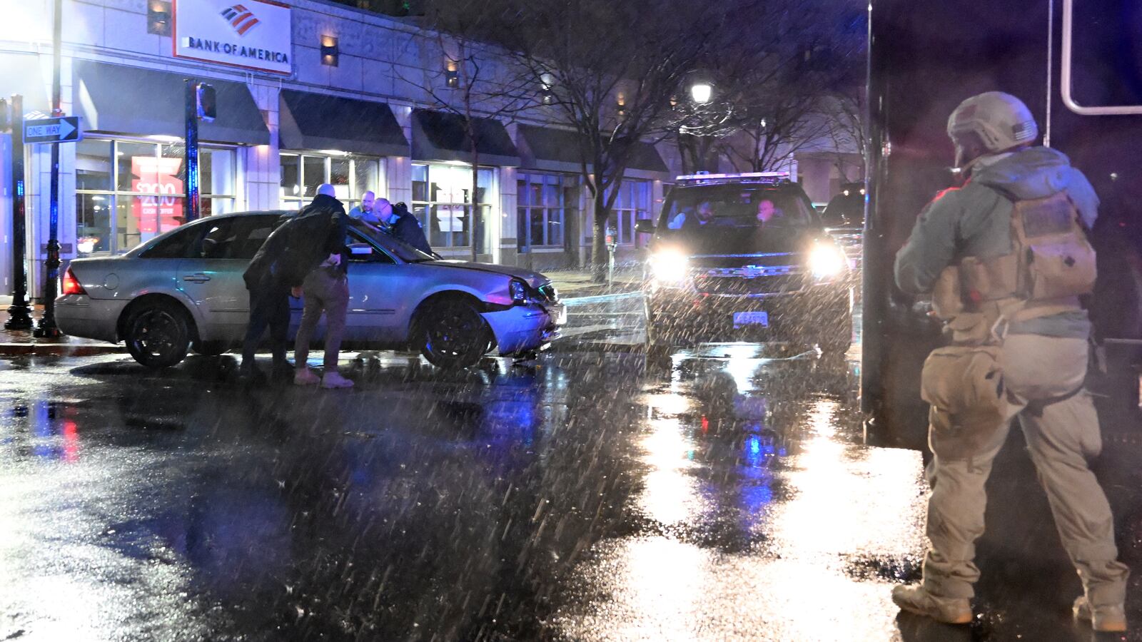 Members of the U.S. Secret Service rush to a car, after it hit a motorcade SUV, as U.S. President Joe Biden was leaving his campaign headquarters in Wilmington, Delaware on Dec. 17, 2023.