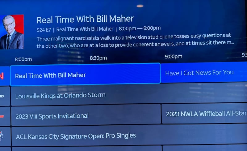 A DirecTV guide blurb for a re-run of Real Time with Bill Maher is highlighted above several sports channels.