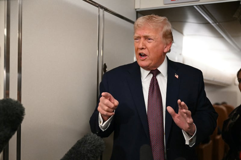 President Donald Trump speaks to the press aboard Air Force One on January 11, 2026.