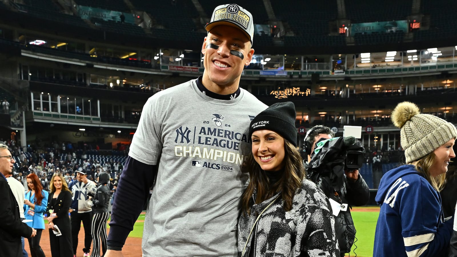 CLEVELAND, OHIO - OCTOBER 19: Aaron Judge #99 of the New York Yankees and wife Samantha Bracksieck pose for photos after the New York Yankees beat the Cleveland Guardians 5-2 in 10 innings in Game Five of the American League Championship Series at Progressive Field on October 19, 2024 in Cleveland, Ohio. (Photo by Jason Miller/Getty Images)