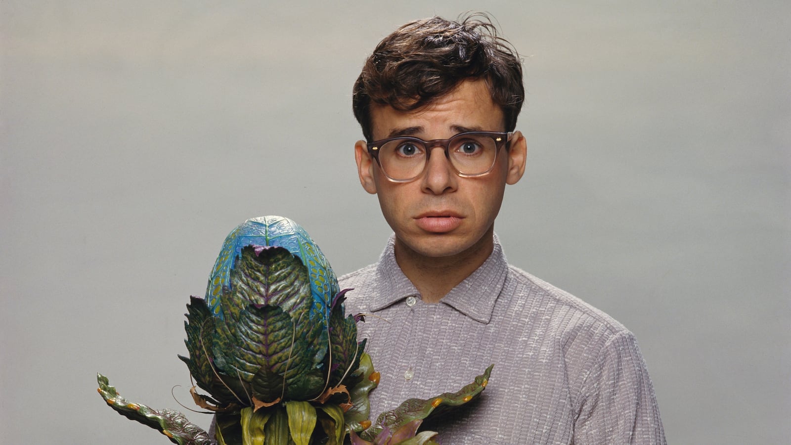 Canadian actor Rick Moranis with the plant Audrey II of the film Little Shop of Horrors, directed by Frank Oz and released in 1986.