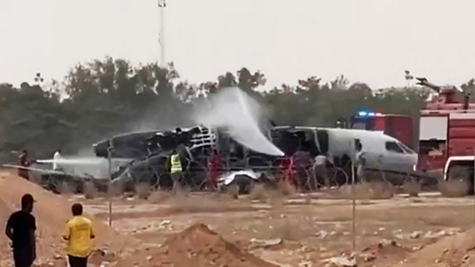Firefighters douse a plane after it crashed at Misrata International Airport, in Misrata, Libya, September 14, 2026.