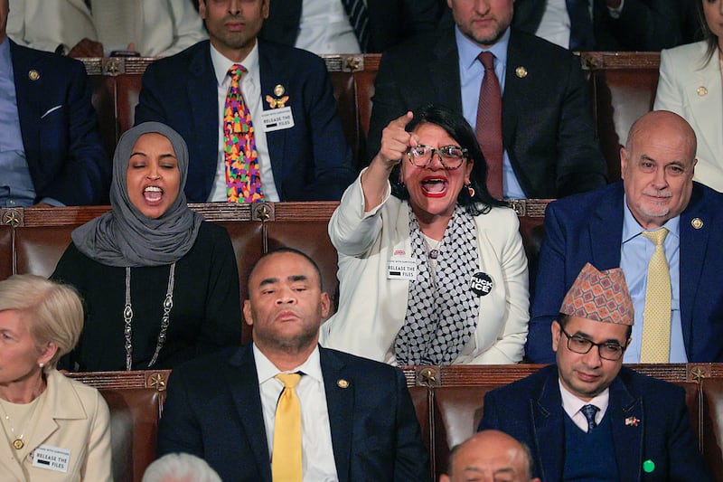 WASHINGTON, DC - FEBRUARY 24: Rep. Rashida Tlaib (D-MI) (R) and Rep. Ilhan Omar (D-MI) shout during U.S. President Donald Trump's State of the Union address during a Joint Session of Congress at the U.S. Capitol on February 24, 2026, in Washington, DC. Trump delivered his address days after the Supreme Court struck down the administration's tariff strategy and amid a U.S. military buildup in the Persian Gulf threatening Iran. (Photo by Chip Somodevilla/Getty Images)