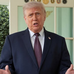 President Donald Trump speaks with the media next to Sharon Simmons after receiving a McDonald's order via DoorDash, which she delivered to him in front of the Oval Office at the White House in Washington, D.C., U.S., April 13, 2026.