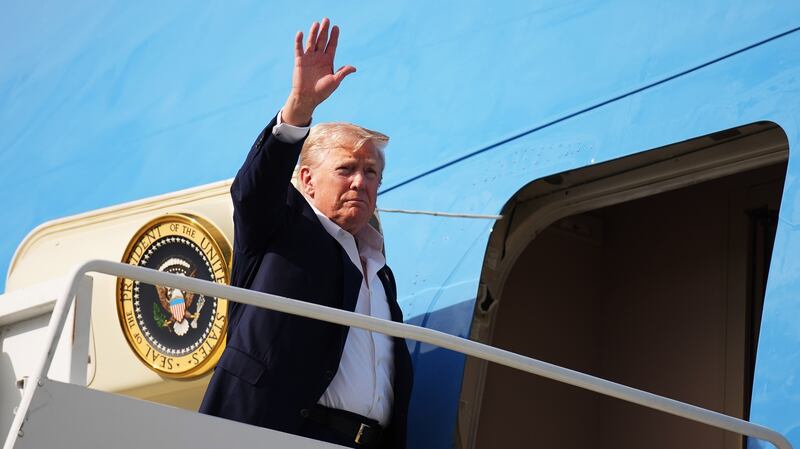 LOSSIEMOUTH, SCOTLAND - JULY 29: U.S. President Donald Trump waves as he boards Air Force One at RAF Lossiemouth, on July 29, 2025 in Lossiemouth, Scotland. President Trump visited Scotland on a trip that was part-vacation, part-work, as he stayed at his Trump Turnberry golf course, followed by the Trump International Golf Links in Aberdeenshire, between July 25 to 29. (Photo by Andrew Harnik/Getty Images)