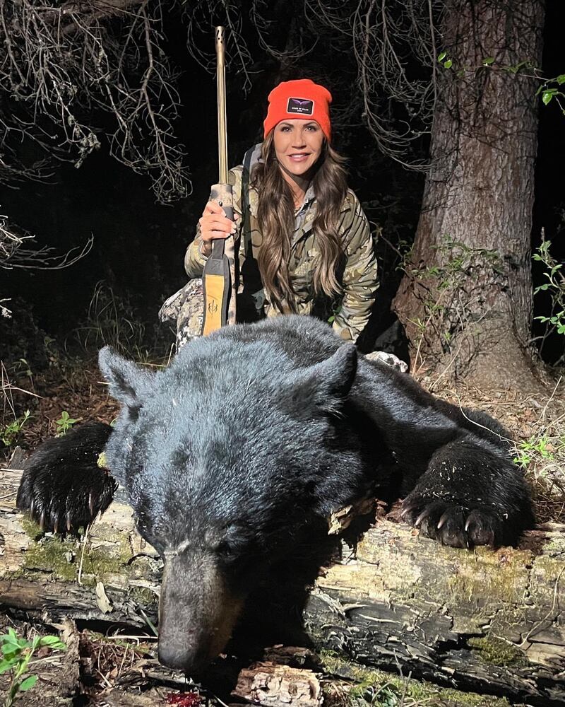 Homeland Security Secretary Kristi Noem posing with a dead bear from a hunt she participated in back in 2023.