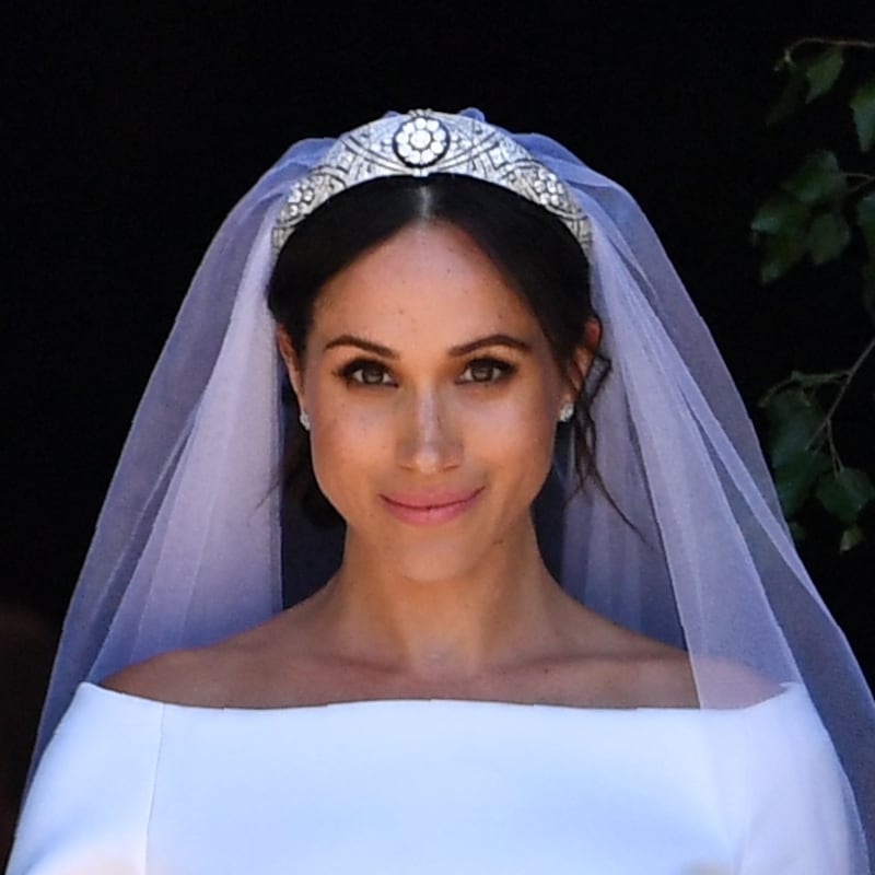 Prince Harry and Meghan Markle walk down the west steps of St. George's Chapel at Windsor Castle on May 19, 2018. Waight designed Markle's sweeping, boatneck Givenchy bridal gown.