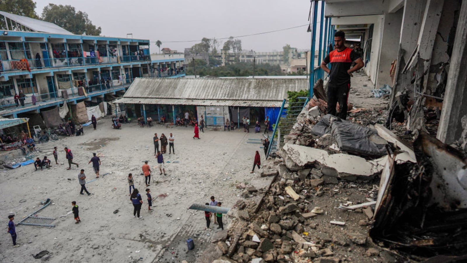 Palestinians check a UN-school housing displaced people that was hit during Israeli bombardment in Nuseirat, in the central Gaza Strip, on June 6, 2024.