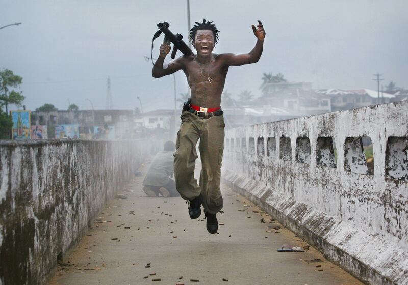 galleries/2012/04/26/charles-taylor-verdict-liberian-warlord-s-alleged-atrocities-photos/liberia-soldier-fire-2003_zee6ho