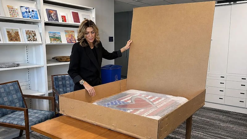 Art in Embassies Director Erin Scavino unboxes Romero Britto artwork for the State Department's "Passport to Patriotism: 250 Years of Diplomacy" exhibition.