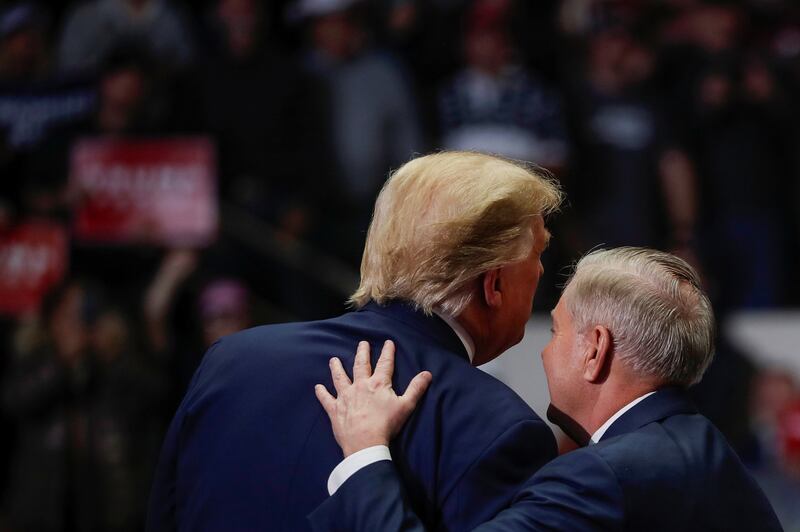 U.S. Senator for South Carolina Lindsey Graham speaks with U.S. President Donald Trump during his campaign rally in Charlotte, North Carolina, U.S., March 2, 2020. REUTERS/Carlos Barria