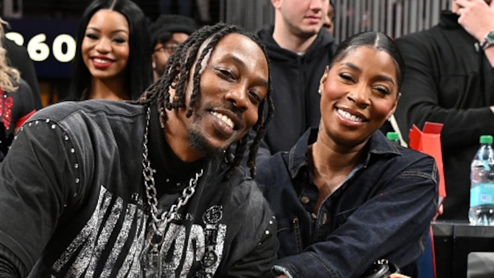 Former NBA Player Dwight Howard and Amy Luciani sit together at an NBA game