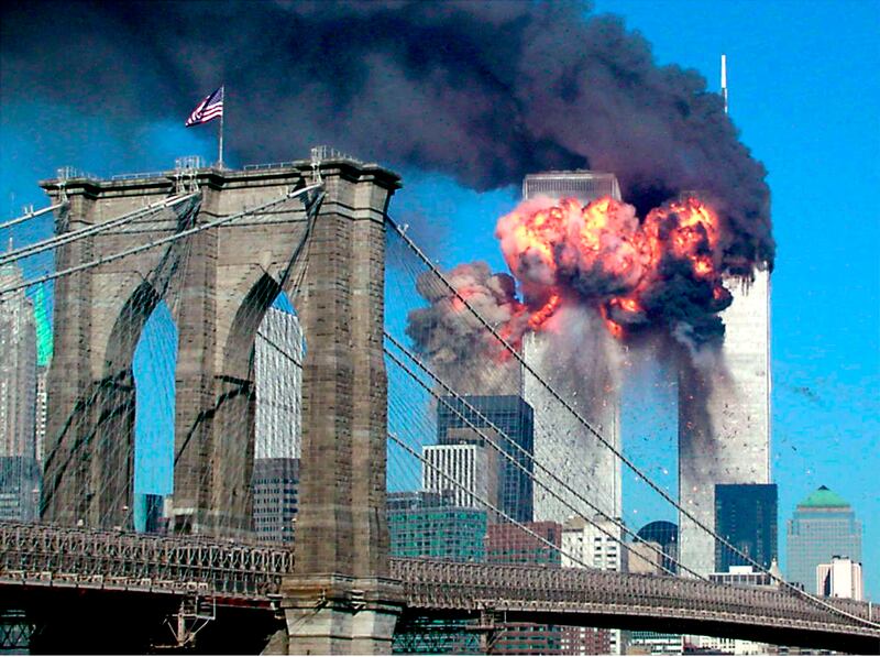 The second tower of the World Trade Center explodes into flames after being
hit by a airplane on September 11, 2001 with the Brooklyn bridge in
the foreground.
