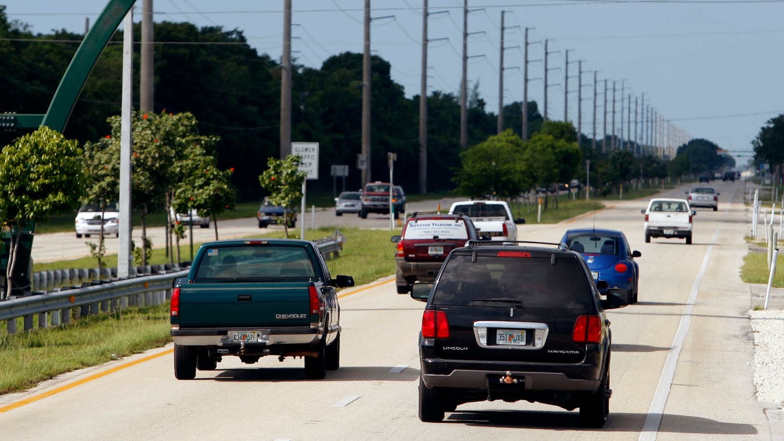 Cars drive down the U.S. 1 highway in Key Largo, Florida, as Hurricane Ike approaches, Sept. 6, 2008.