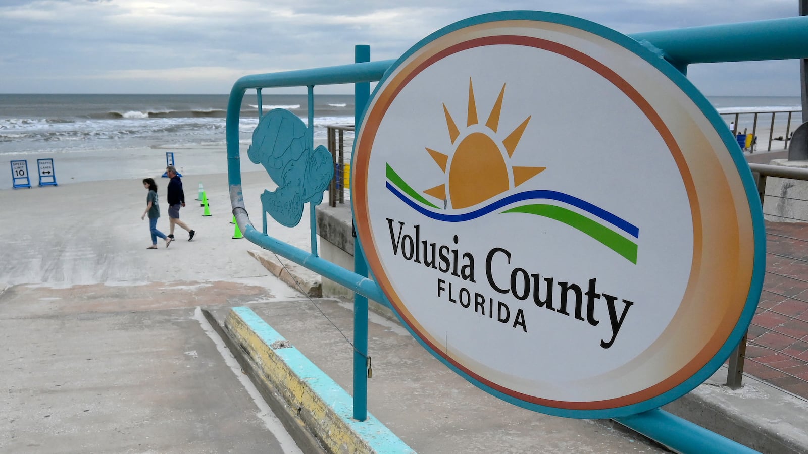 People walk past an access ramp at New Smyrna Beach in Volusia County, Florida, the area with the most shark attacks in the world, on February 23, 2024.