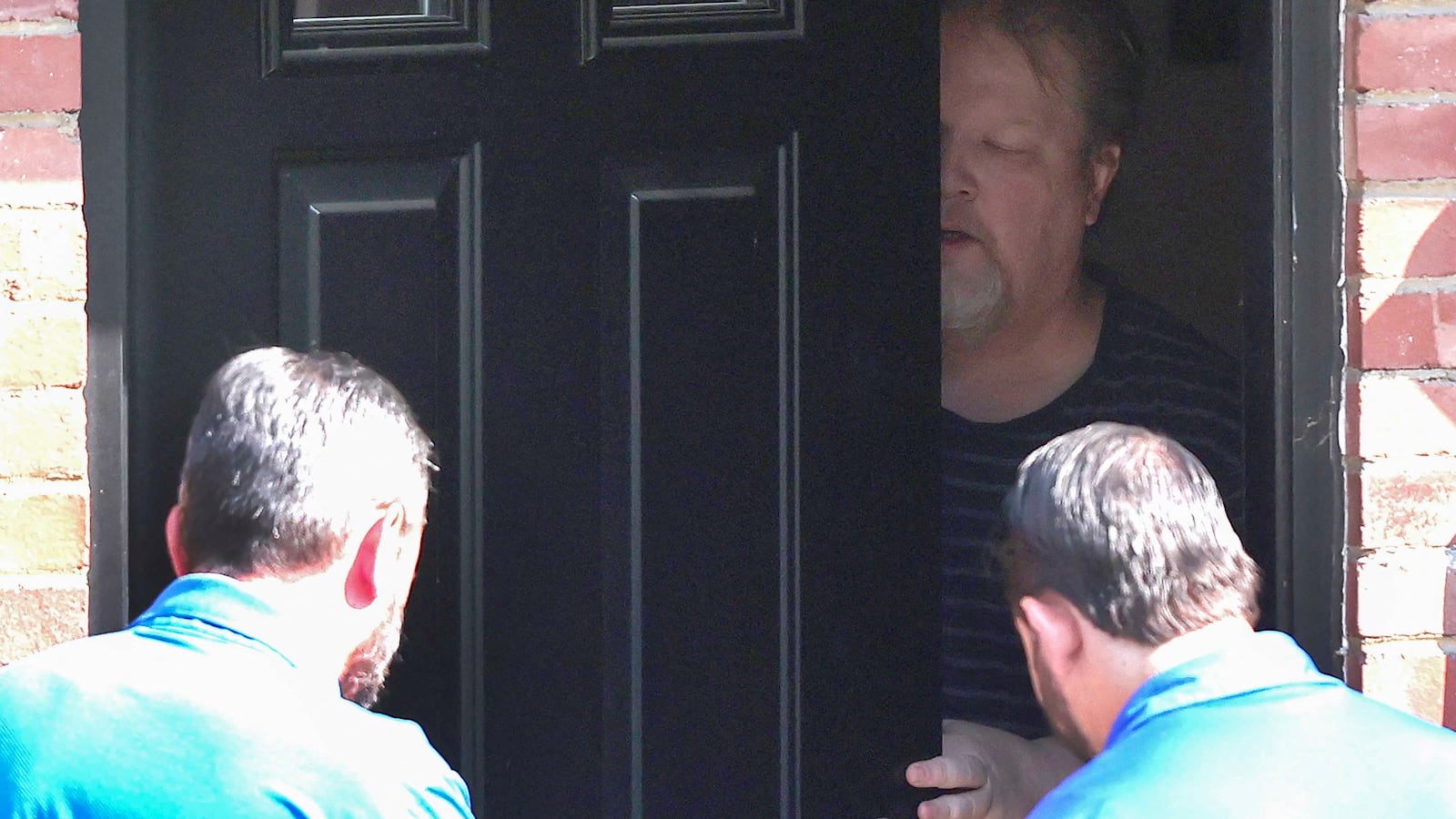 Matthew Crooks opens his door to investigators.