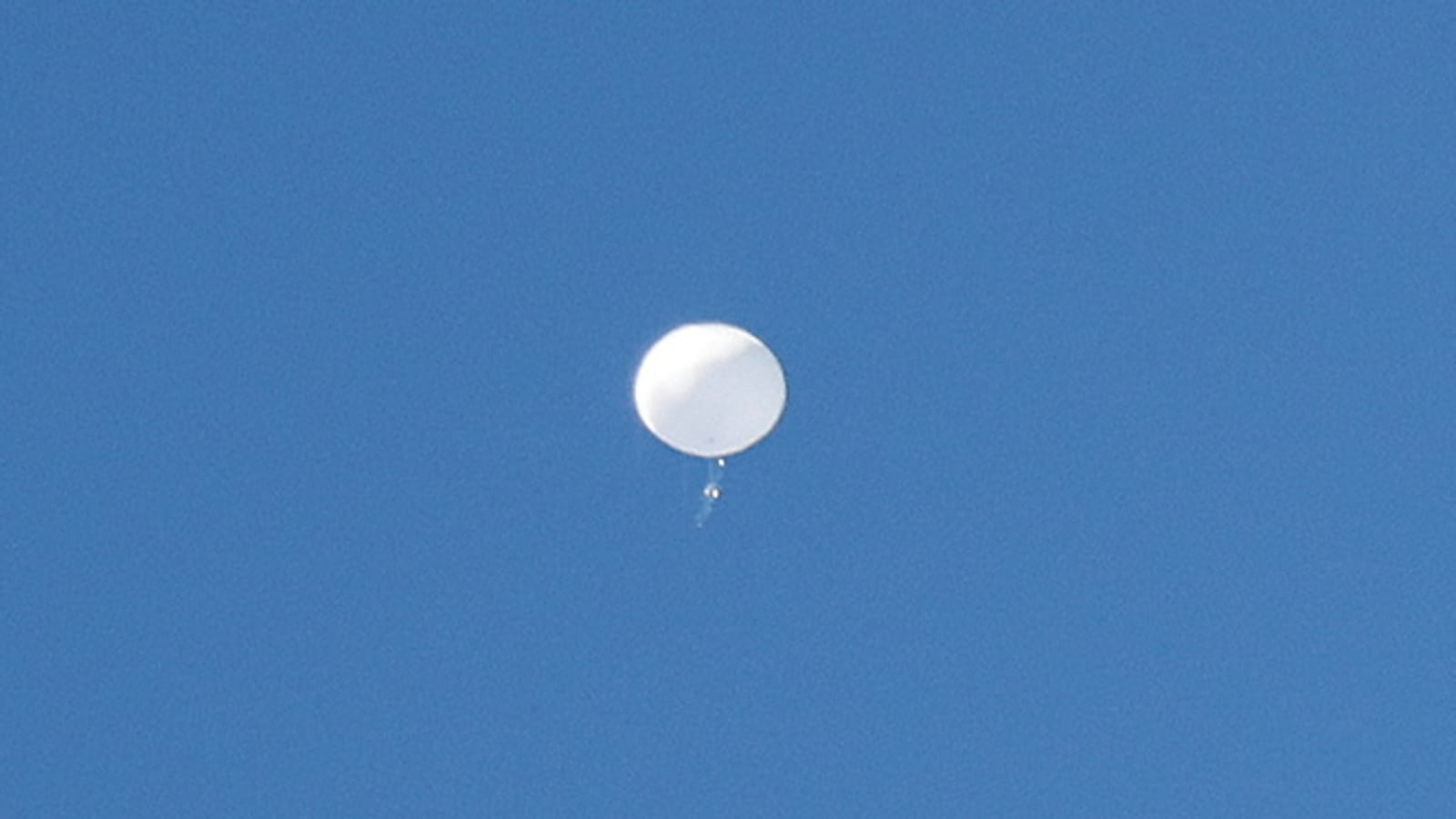 A jet flies by a suspected Chinese spy balloon as it floats off the coast in Surfside Beach, South Carolina, U.S. February 4, 2023.