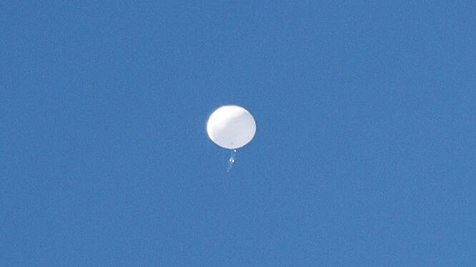 A jet flies by a suspected Chinese spy balloon as it floats off the coast in Surfside Beach, South Carolina, U.S. February 4, 2023.