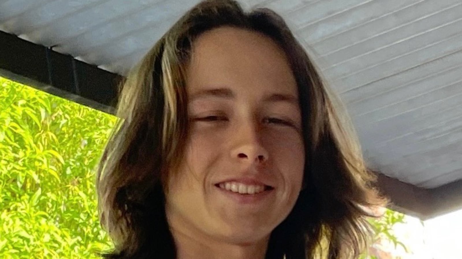 A photo of Dorian Zev Kweller in a white tank top