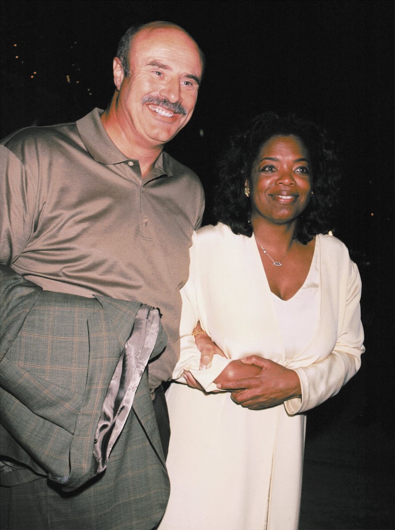 Talk show host Oprah Winfrey poses with Dr. Phil at Spago restaurant August 5, 2001 in Hollywood, CA.