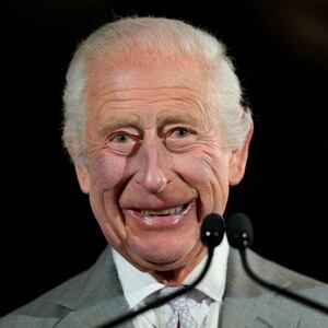 King Charles III smiles.