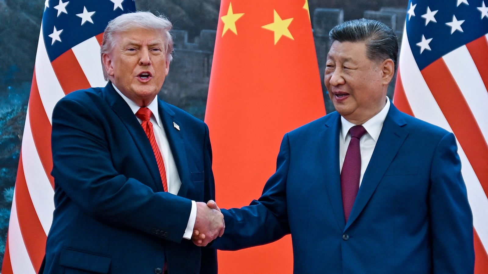US President Donald Trump (R) shakes hands with China's President Xi Jinping at the Great Hall of the People in Beijing on May 14, 2026. (Photo by Kenny HOLSTON / POOL / AFP via Getty Images)