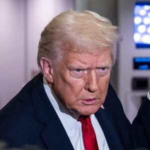 President Donald Trump speaks to the media aboard Air Force One