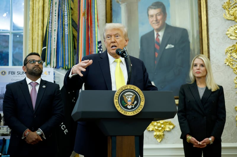 U.S. President Donald Trump speaks as Federal Bureau of Investigation Director Kash Patel (L) and U.S. Attorney General Pam Bondi look on during a press conference in the Oval Office of the White House on October 15, 2025 in Washington, DC.