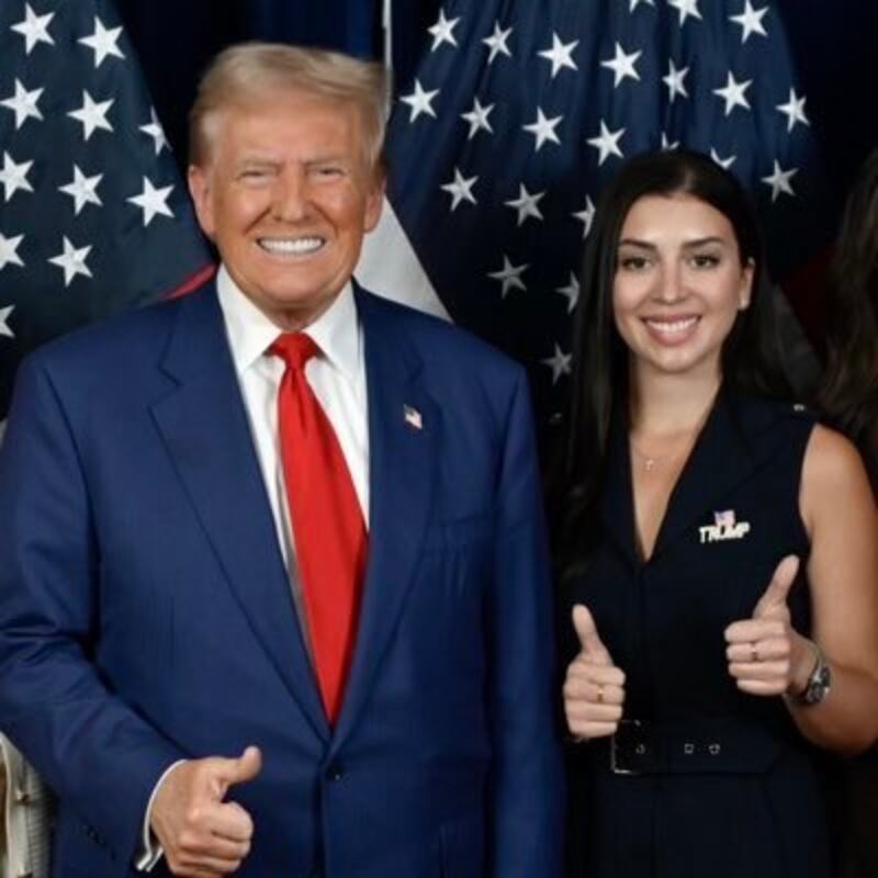 Donald Trump gives "thumbs-up" with Julia Varvara.