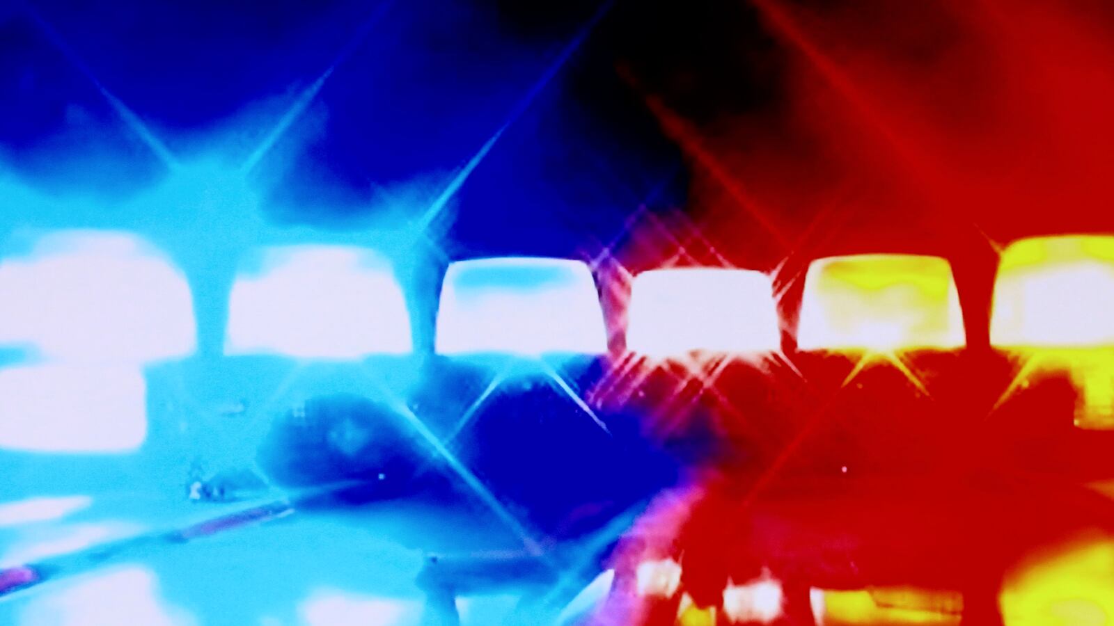 Police sirens blare.