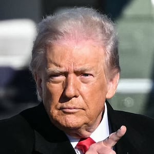 US President Donald Trump gestures as he walks to board Air Force One at Joint Base Andrews, Maryland on January 13, 2026.