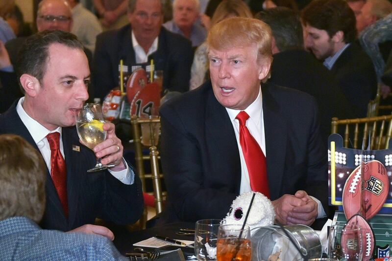 US President Donald Trump chats with White House Chief of Staff Reince Priebus while watching Super Bowl LI at Trump International Golf Club Palm Beach in West Palm Beach, Florida on February 5, 2017.