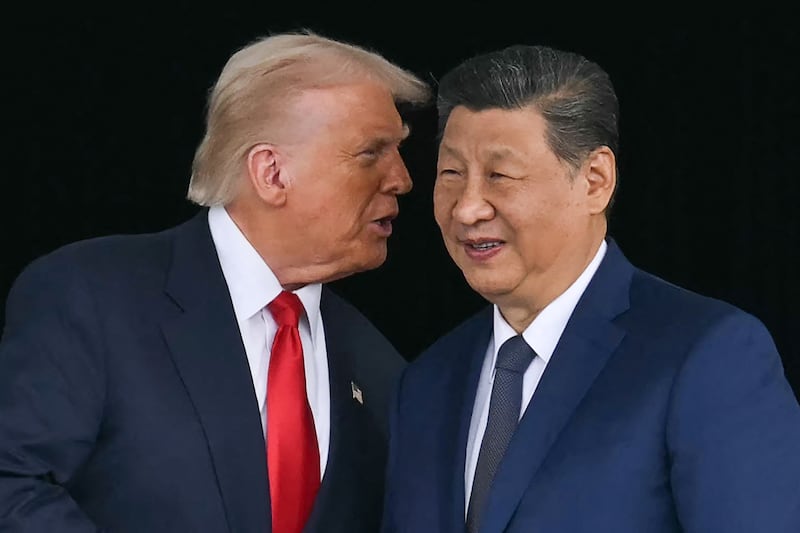 US President Donald Trump (L) talks to China's President Xi Jinping.