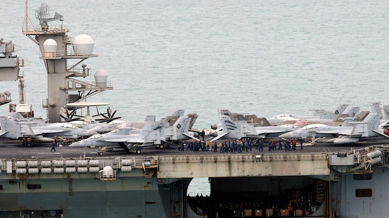 Sailors gather next to jet fighters on the US Navy nuclear-powered aircraft carrier USS Abraham Lincoln (CVN-72) before docking at the Laem Chabang deep-sea port in Laem Chabang, Chonburi province, Thailand, 02 September 2026. The Nimitz-class nuclear-powered aircraft carrier USS Abraham Lincoln, with roughly 5,000 sailors and Marines aboard and other vessels from its Carrier Strike Group, is docked with personnel to come ashore in Thailand from 02 to 06 September 2026, to rest and recuperate while the warship replenishes supplies after an extended deployment for operations in the Middle East.