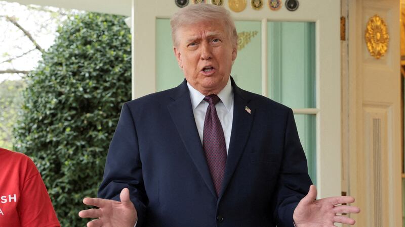 President Donald Trump speaks with the media next to Sharon Simmons after receiving a McDonald's order via DoorDash, which she delivered to him in front of the Oval Office at the White House in Washington, D.C., U.S., April 13, 2026.
