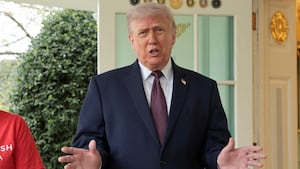 President Donald Trump speaks with the media next to Sharon Simmons after receiving a McDonald's order via DoorDash, which she delivered to him in front of the Oval Office at the White House in Washington, D.C., U.S., April 13, 2026.